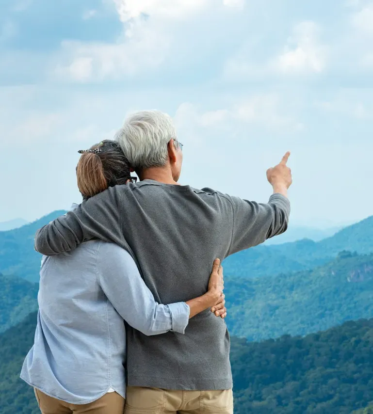 Happy elderly couple walking together on a sunny day